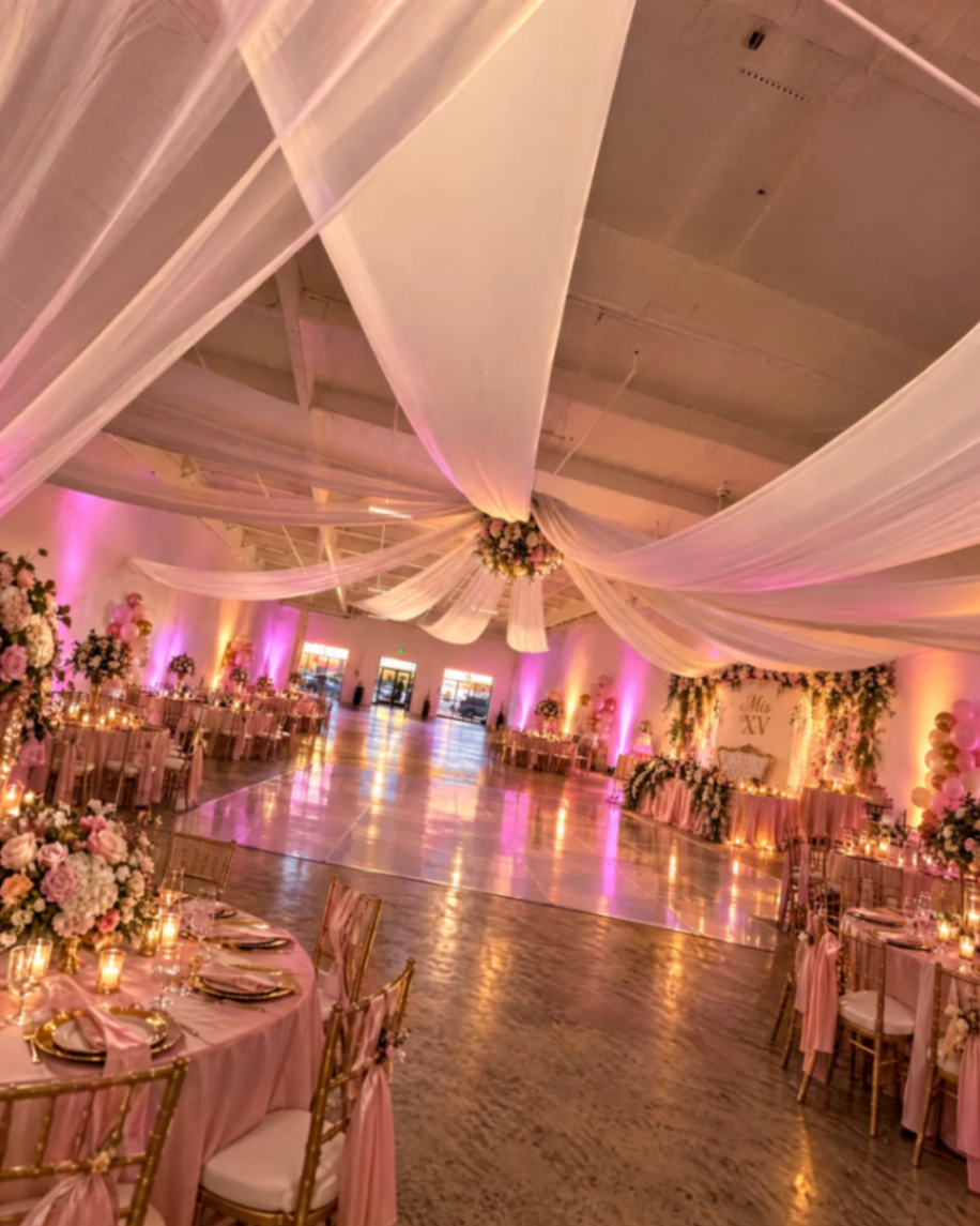 Pink floral celebration with a dance floor and ceiling drapery at The Zion