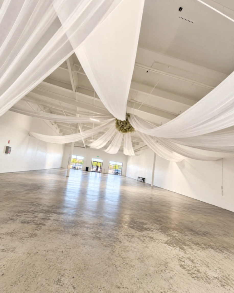 Open venue floor beneath white ceiling drapery at The Zion
